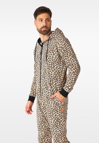 Leopard print onesie made of soft fabric, featuring a zip front, black accents on the hood and cuffs, and side pockets.