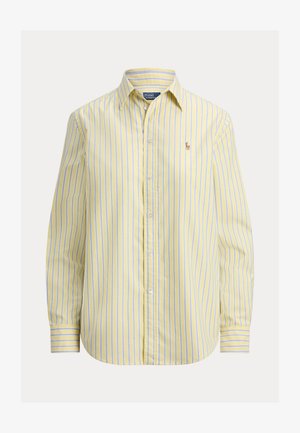 Geltonas dryžuotas marškinėlis su mėlynomis juostelėmis, ilgomis rankovėmis, apykakle ir mažu siuvinėtu logotipu kairėje krūtinės pusėje.