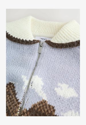 Knit zip-up sweater in light blue with cream collar, brown accents, and cloud patterns. Features a textured finish and silver zipper.
