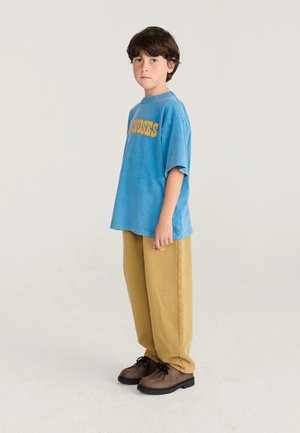 Bobo Choses, TAXI SAURUS TAG COCOON - Pantaloni sportivi - beige