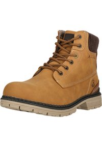 Tan-nahkaiset saappaat, joissa on korkea nilkka, pyöreä kärki, ruskeat nauhat ja musta kumipohja, jossa on kuvio. Korostusommeltuja saumoja näkyvissä.