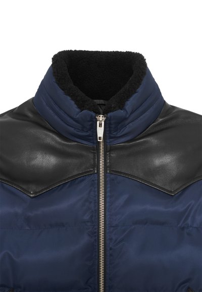 Marineblaue Steppjacke mit schwarzen Lederakzenten an den Schultern, hohem Kragen und Reißverschluss. Weiches, strukturiertes Innenfutter.