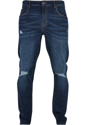 Dunkelblaue Slim-Fit-Jeans aus Denim mit durchgewetzten Stellen und leicht fransigen Knien. Klassisches Fünf-Taschen-Design und Messingbeschläge.