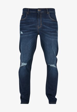 Dunkelblaue Slim-Fit-Jeans aus Denim mit durchgewetzten Stellen und leicht fransigen Knien. Klassisches Fünf-Taschen-Design und Messingbeschläge.