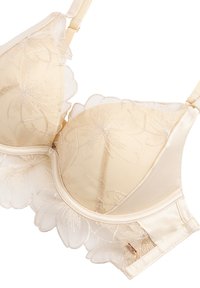 Beige Spitze-BH mit floralem Stickerei, Unterdraht, verstellbaren Trägern und Wellenkanten auf transparentem Mesh-Gewebe.