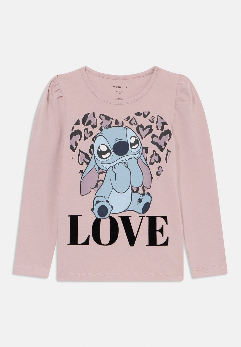 Ροζ μπλούζα με μακριά μανίκια που απεικονίζει έναν μπλε καρτούν χαρακτήρα, κείμενο "LOVE" σε μαύρο και φόντο με λεοπάρ σχεδίαση. Μαλακό υλικό από βαμβάκι.