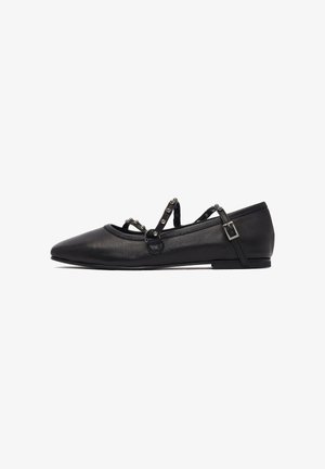 Ballerines noires avec un bout pointu, en cuir lisse, et des brides décoratives à la cheville avec des accents métalliques. Semelle plate.