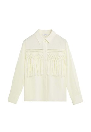 Blusa de manga larga color crema con botones en la parte delantera, cuello puntiagudo y detalle de flecos trenzados horizontales a lo ancho del pecho.