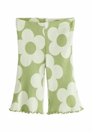 Grønne ribstrikkede shorts med store hvide marguritblomstermønstre og salatkantede kanter.