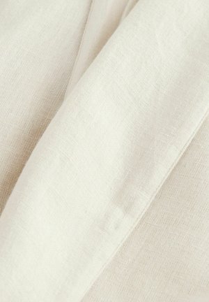 Linen w kolorze ecru z subtelną teksturą, z gładkimi i nieco pomarszczonymi obszarami, ukazujący naturalne włókna.