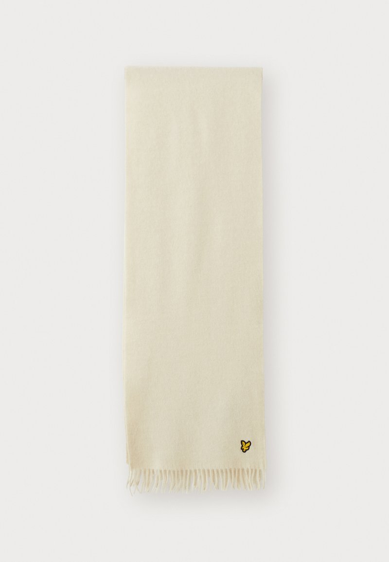 Écharpe beige en tissu doux, avec des bords frangés et un petit logo de papillon jaune dans le coin inférieur.