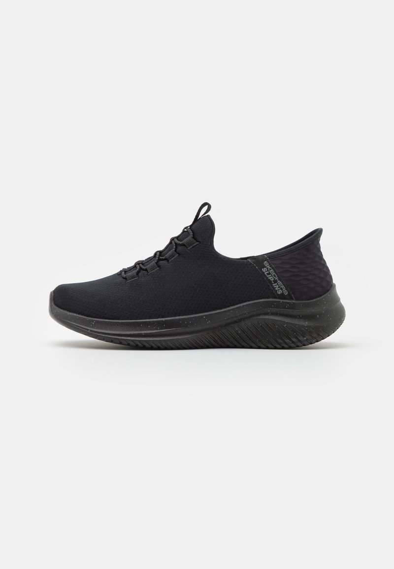 Black athletic shoe with a textured upper, elastic lacing system, padded collar, and a contoured sole featuring a speckled design.
