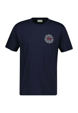 Navyblaues Baumwoll-T-Shirt mit Rundhalsausschnitt und kurzen Ärmeln. Verfügt über einen kreisförmigen Logodruck auf der linken Brust mit Textdetails.