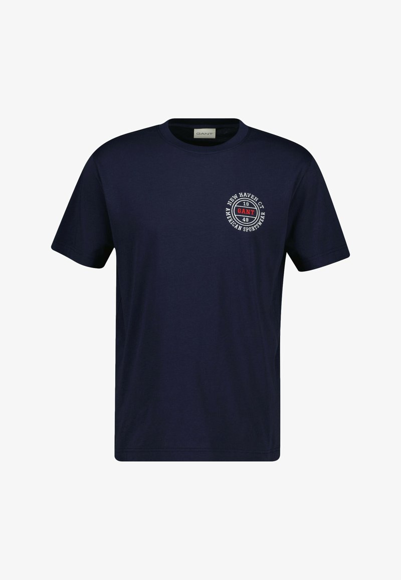 Marineblauw katoenen t-shirt met een ronde hals en korte mouwen. Voorzien van een cirkelvormige logo-afdruk op de linkerbovenkant met tekstdetails.