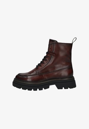 Braune Lederknöchelstiefel mit runder Zehenform, schwarzen Schnürsenkeln, gepolstertem Kragen und dicker Gummisohle mit auffälligem Profil.