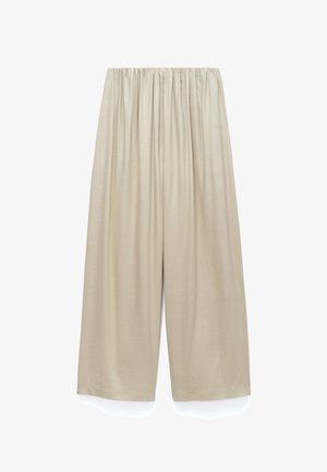 Beige wijde broek met elastische tailleband en een losse, comfortabele pasvorm, getoond op een witte achtergrond.