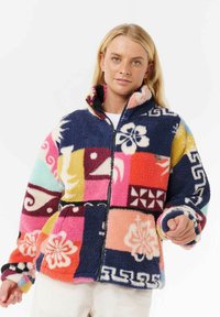 Veste en polaire avec un mélange de motifs patchwork colorés en rose, marine, jaune et menthe, dotée d'une fermeture éclair sur le devant et d'un col haut.