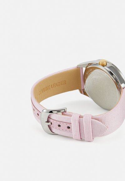 Pink leather watch strap with textured finish, silver stainless steel hardware, and a gold crown. Engraved "Genuine Leather" on the inner side.