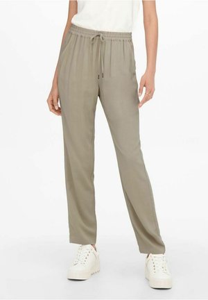 Lightweight, olive-green trousers with an elastic waistband and drawstring. Straight-leg design, soft texture, paired with white platform sneakers.
