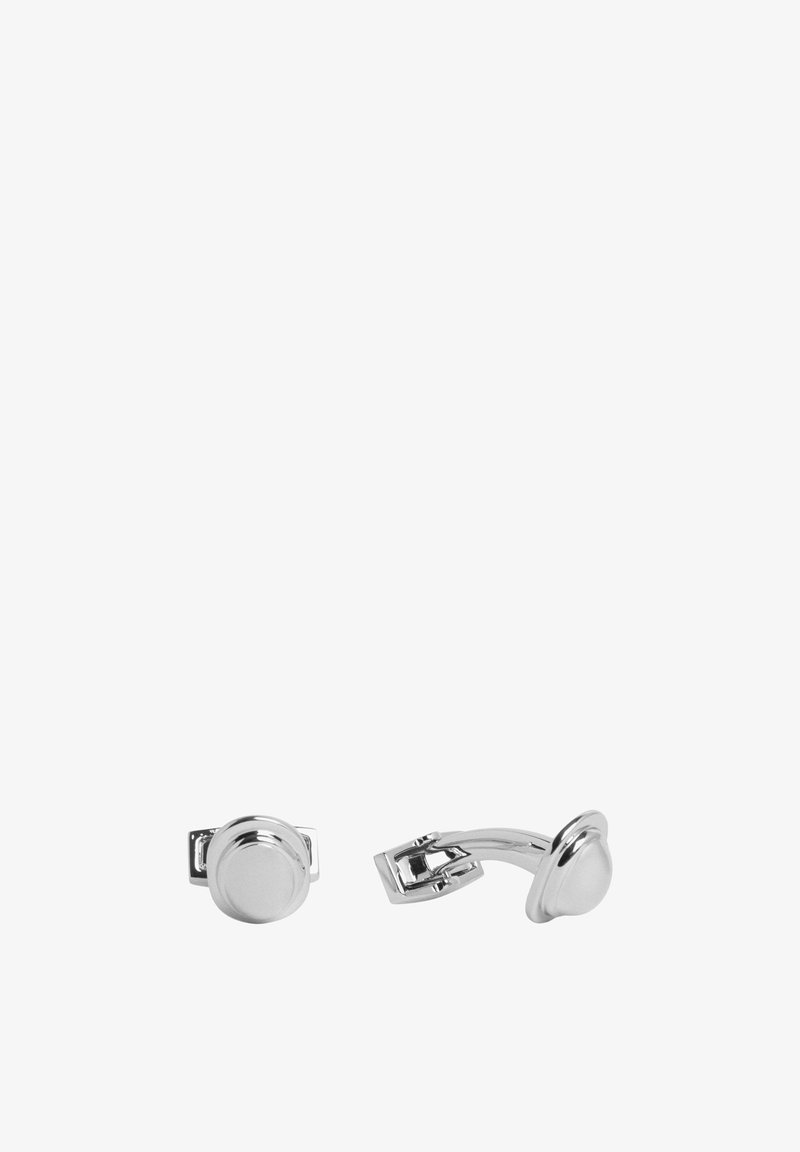 Hopeakynsikkäät, joissa on pyöreä muotoilu ja kiiltävä pinta. Kiinnitysmekanismi on yksinkertainen saranaolkki.