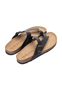 Black leather sandals with adjustable buckle, cork footbed, and textured rubber sole. Open design for breathability and comfort.