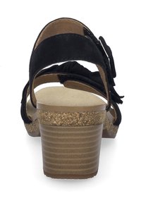 Sorte ruskind hælsandaler har en korktekstureret hæl, åben bag, og dekorative stofdetaljer på stropperne for ekstra pynt.