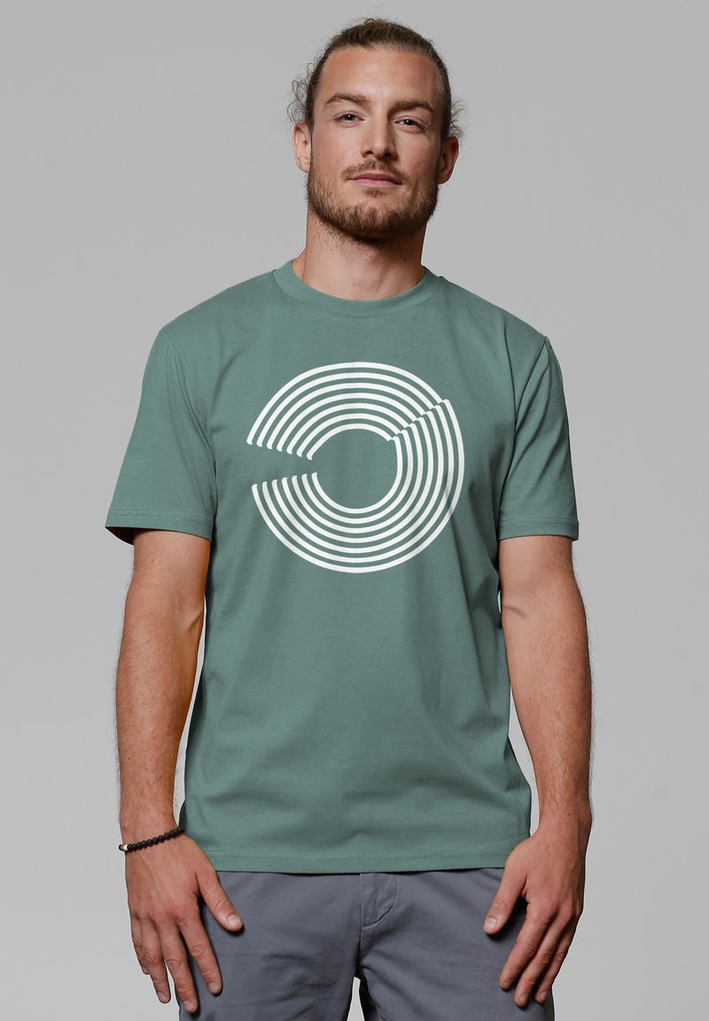 Grünes Baumwoll-T-Shirt mit einem weißen, konzentrischen Kreisdesign auf der Vorderseite. Rundhalsausschnitt, kurze Ärmel und lockere Passform.