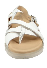 White leather sandal with multiple crisscross straps, padded beige insole, and a light-colored rubber sole. Features a buckle closure.