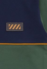 Short-sleeve shirt featuring navy blue and green color blocks, with a yellow accent and a rectangular patch displaying angled stripes in brown.