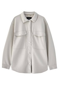 Chemise-veston boutonnée beige clair avec col, manches longues, deux poches à rabat sur le devant avec boutons-pression argentés, et coutures apparentes.