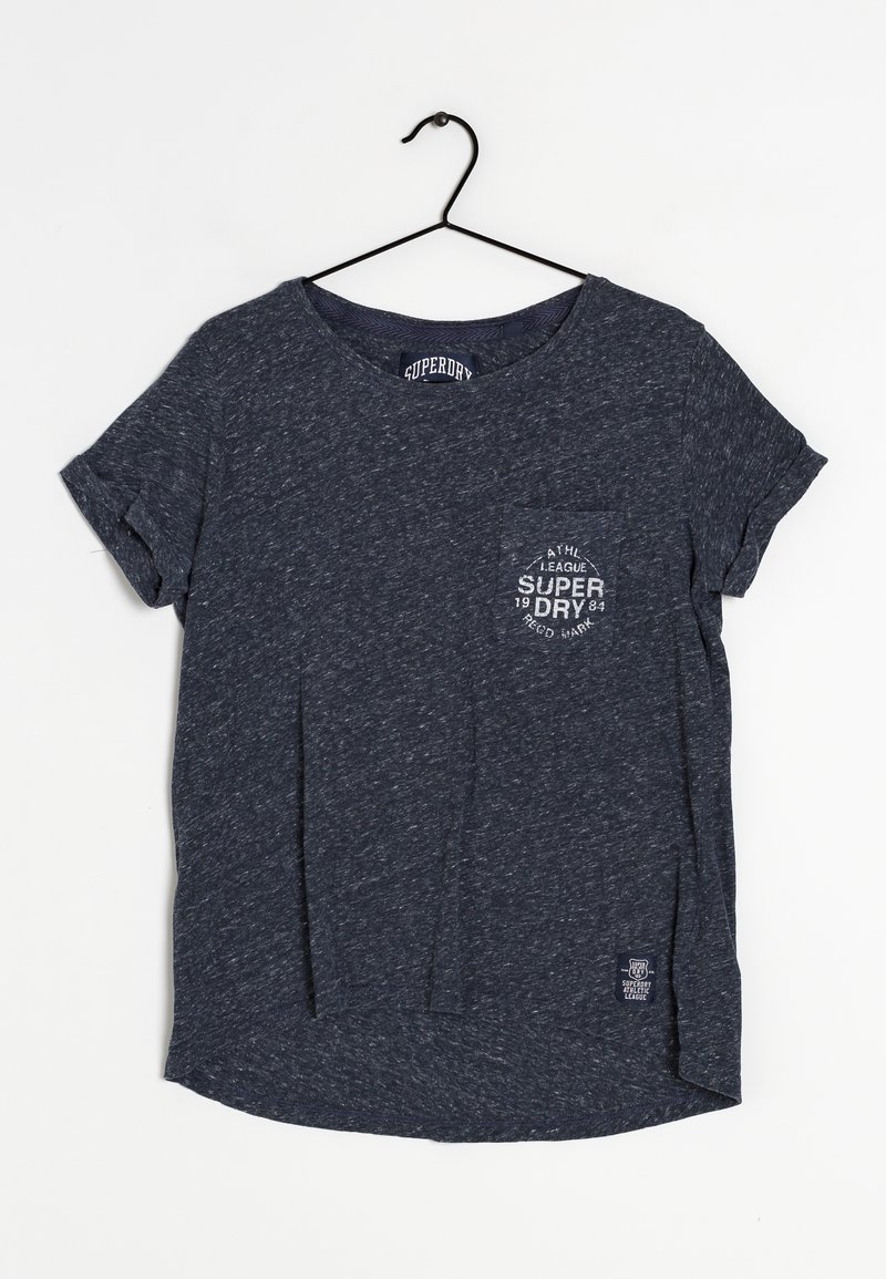 T-shirt à manches courtes bleu marine en coton texturé, avec une poche poitrine ornée d'un logo circulaire et un motif chiné subtil.