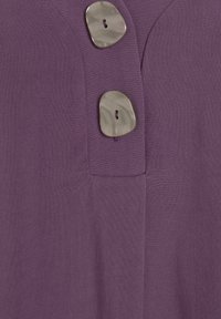 Top in tessuto viola con due bottoni decorativi grigi dalla superficie liscia, che offrono un dettaglio di design testurizzato e su misura.