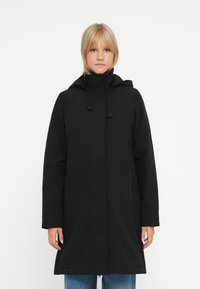 Black long coat featuring a hood, front zipper, and two side pockets. Made from durable fabric with a smooth texture. Straight cut design.