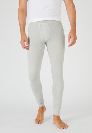 Leggings de color gris claro fabricados con una tela suave, que presentan un diseño ajustado con un bolsillo frontal. La tela tiene una textura suave y un ligero estiramiento.