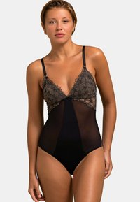 Bodysuit en dentelle noire avec des détails floraux en dentelle sur le haut et un design en maille transparente. Des bretelles fines et réglables complètent le look.