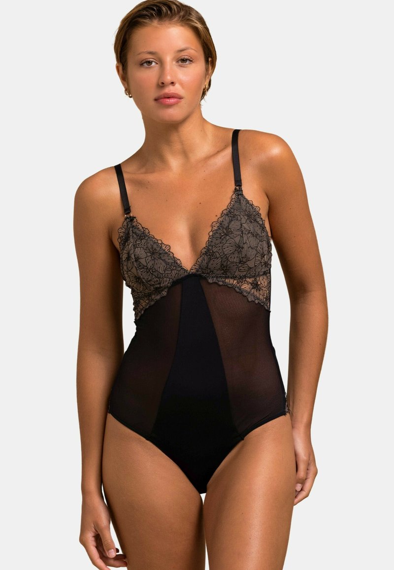 Bodysuit en dentelle noire avec des détails floraux en dentelle sur le haut et un design en maille transparente. Des bretelles fines et réglables complètent le look.