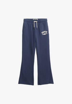 Marineblaue Jogginghosen mit weißem Kordelzug, ausgestellten Beinen und dem Aufdruck „SUPER 1985“ in Weiß auf dem oberen linken Oberschenkel.