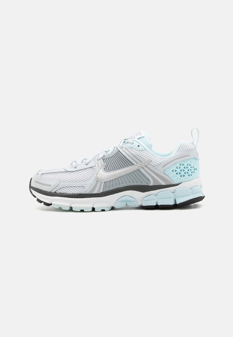 Light grey running shoe with mesh upper, silver accents, adjustable laces, cushioned sole, and turquoise accents on the heel and sole.
