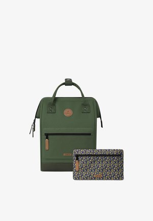 Green backpack with textured fabric, a front zip pocket, and dual handles. Accompanied by a small floral-patterned pouch in navy and yellow.