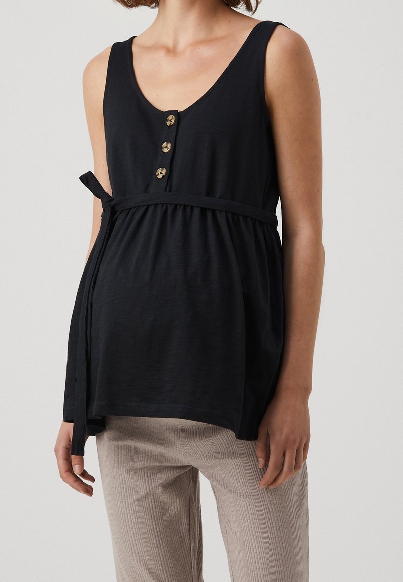 Débardeur noir avec un col en V, quatre boutons dorés et une taille à lacer ajustable. Tissu léger avec une finition légèrement texturée.