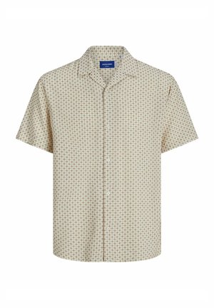Camisa de manga corta de color beige claro con un estampado en forma de cruz en marrón. Presenta un collar puntiagudo y cierre de botones en la parte delantera.