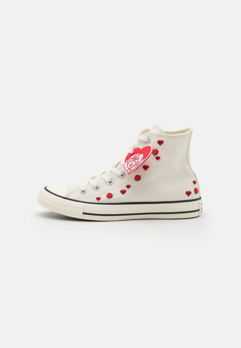 High-top canvas sneaker in off-white with red heart designs and a rose graphic, black sole trim, and silver eyelets.