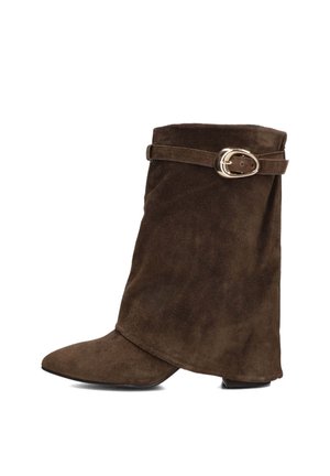 Brown suede ankle boot with a pointed toe, folded design, and a side strap featuring a gold-toned buckle accent. Flat heel.