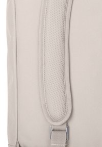 Light gray backpack featuring a textured, padded shoulder strap with perforations, metallic hardware, and a smooth fabric body.