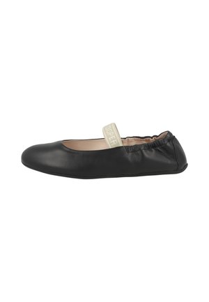 Black leather ballet flat with elastic beige strap across the top and gathered heel detail, viewed from the side.