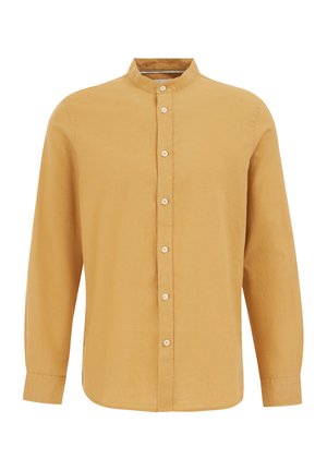 Chemise à manches longues en jaune moutarde, avec un col montant, une patte de boutonnage sur le devant et un tissu doux et texturé. Coupe décontractée avec un ourlet droit.