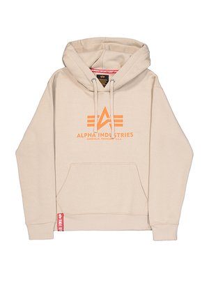 Beige kapucnis pulóver kenguruzsebbel, narancssárga "ALPHA INDUSTRIES" logós felirattal, húzózsinórral ellátott kapucnival, és piros márkajelzéssel a bal alsó szegélynél.