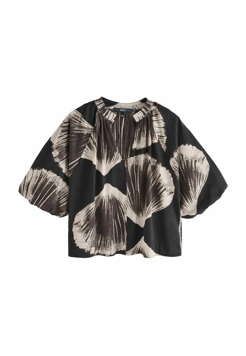 T-shirt noir avec un imprimé floral dans des tons beiges, doté de manches bouffantes et d'un col froncé. Fabriqué en tissu léger.