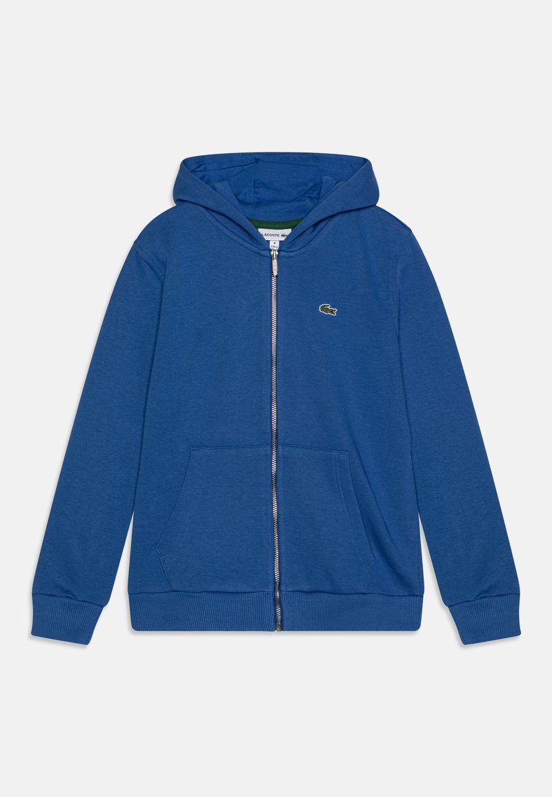 Blå dragkedja hoodie gjord av ett mjukt tyg. Har en känguruficka, ribbade ärmmuddar och en liten logotyp på bröstet. Texturerad finish.