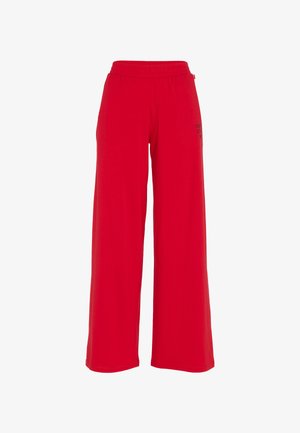 Rode wijde broekspijpen gemaakt van een zachte stof, met een elastische tailleband en zwarte logo-details aan één kant. Zachte textuur overal.